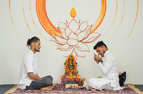Yoga students performing advanced yoga poses in Rishikesh